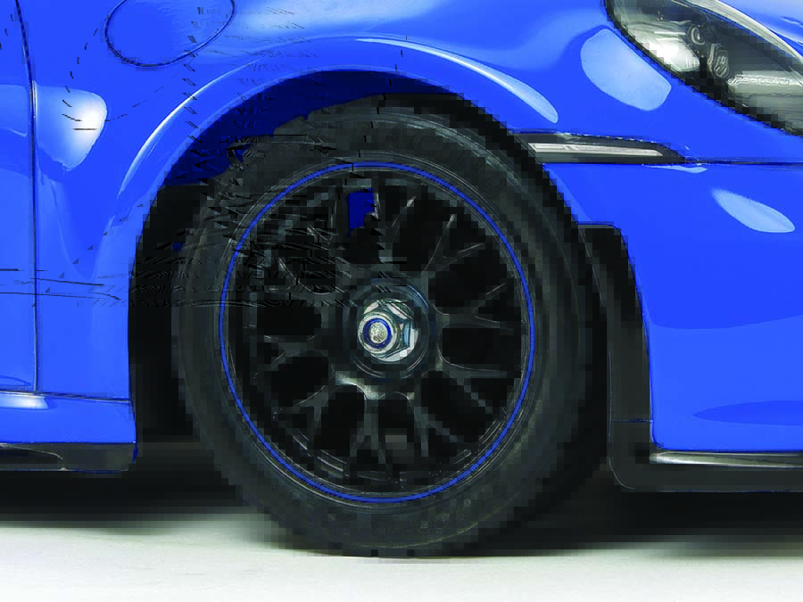 The 992 GT3’s dark gun metal color spoke wheels are paired with racing
radial tires. 