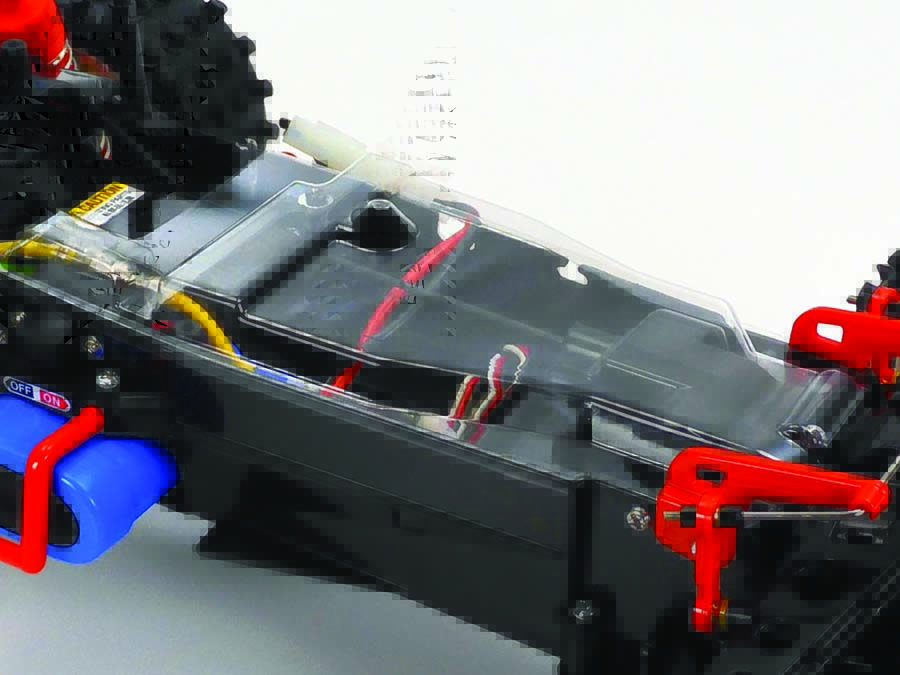 A dust cover for the steering servo and chassis helps keep dirt and debris away from critical areas.